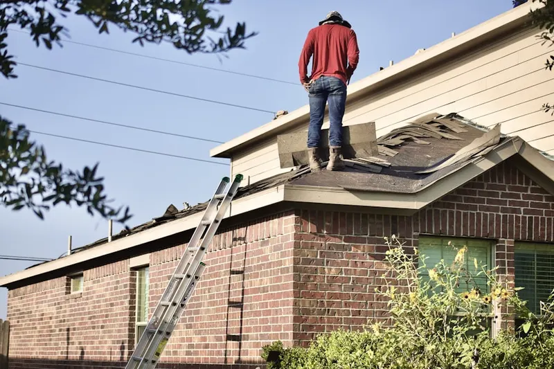 Professional roofer working on a residential roof in Westworth